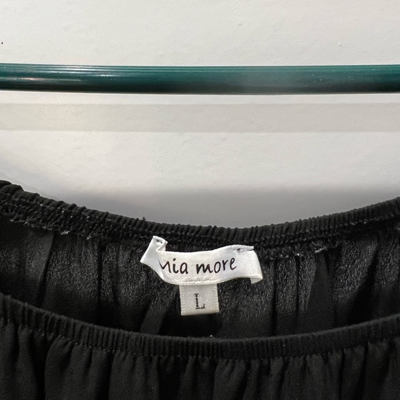 Black top with bell sleeves and lace trim. - Picture 3 of 4